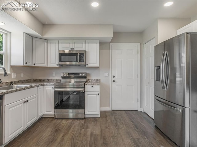 kitchen featuring white cabinetry, sink, dark hardwood / wood-style floors, and stainless steel appliances