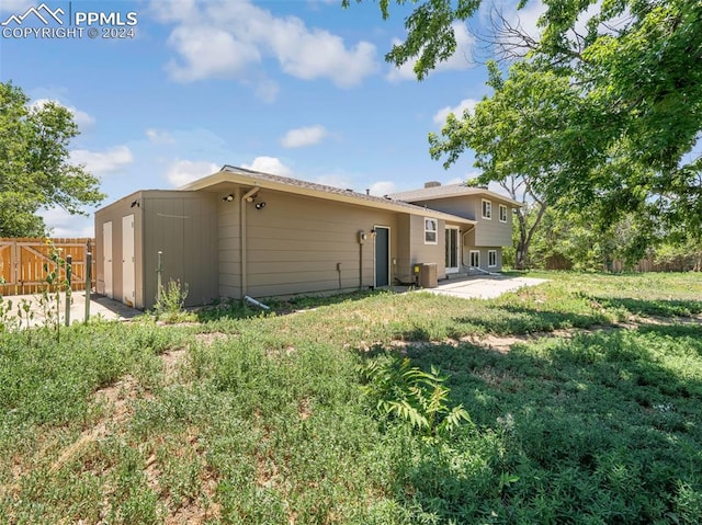 view of home's exterior featuring a yard and a storage shed