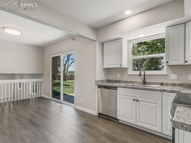 kitchen with sink, white cabinets, a wealth of natural light, and appliances with stainless steel finishes