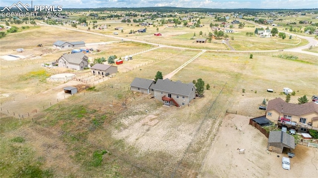 birds eye view of property featuring a rural view