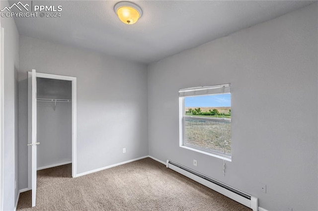 unfurnished bedroom featuring a closet, carpet, and a baseboard radiator