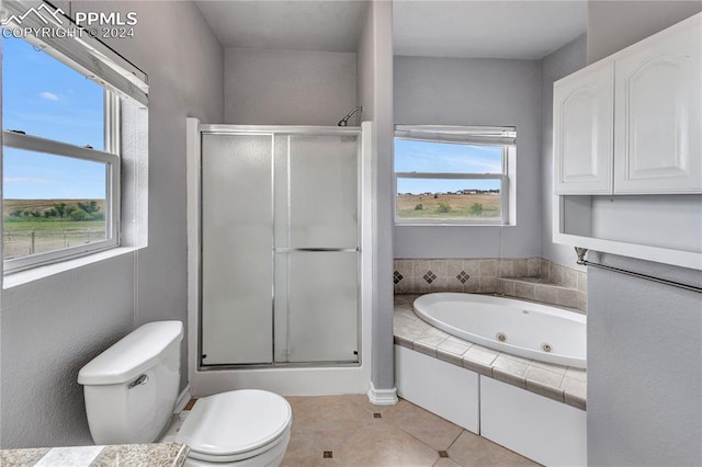 bathroom with tile patterned floors, a healthy amount of sunlight, toilet, and independent shower and bath