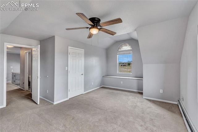 bonus room with a baseboard radiator, ceiling fan, lofted ceiling, and light colored carpet