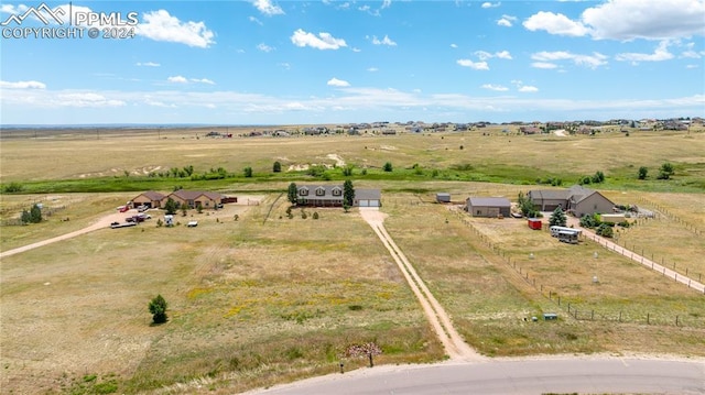 birds eye view of property with a rural view