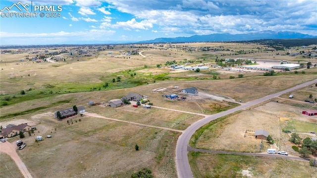 birds eye view of property with a mountain view and a rural view