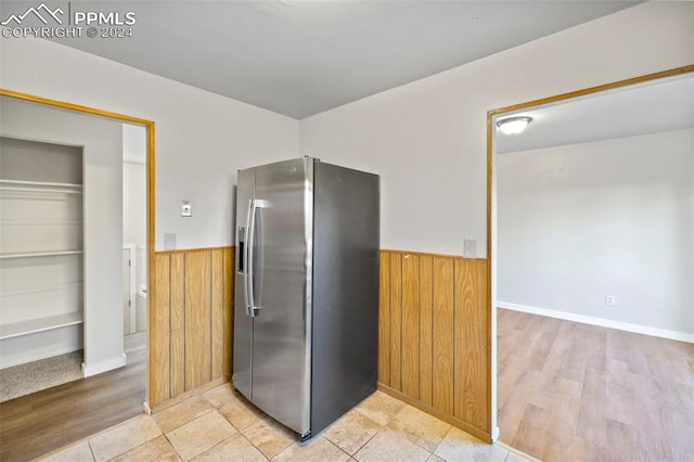 kitchen featuring built in shelves, stainless steel fridge with ice dispenser, and light wood-type flooring