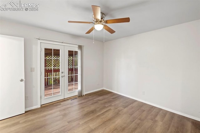 unfurnished room featuring french doors, light hardwood / wood-style flooring, and ceiling fan