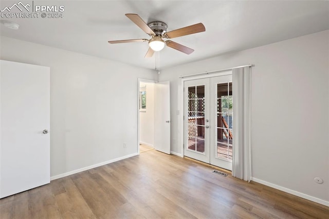 empty room with french doors, hardwood / wood-style floors, and ceiling fan