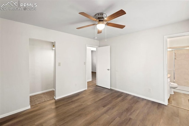 unfurnished bedroom with ceiling fan, connected bathroom, and dark hardwood / wood-style flooring