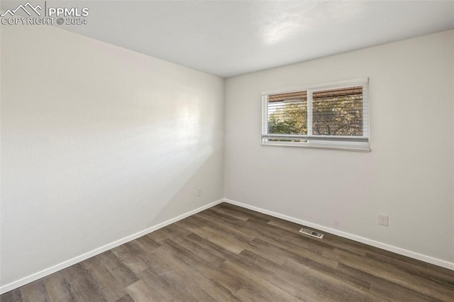 unfurnished room with dark hardwood / wood-style floors