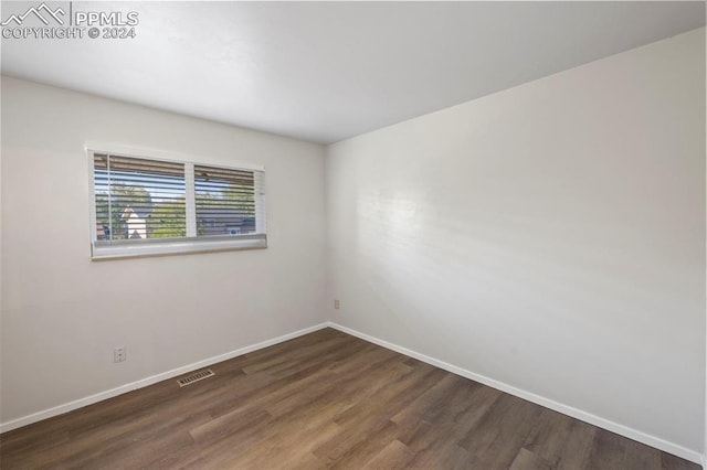 spare room featuring dark hardwood / wood-style flooring