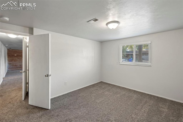 empty room featuring dark carpet