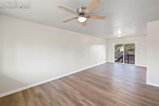 empty room featuring hardwood / wood-style floors and ceiling fan