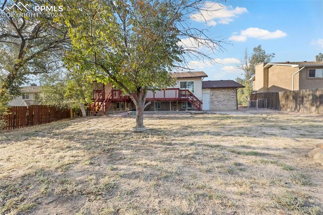 back of house with a wooden deck