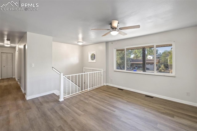 spare room featuring wood-type flooring and ceiling fan