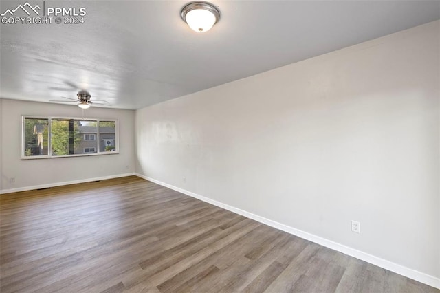 spare room with ceiling fan and wood-type flooring