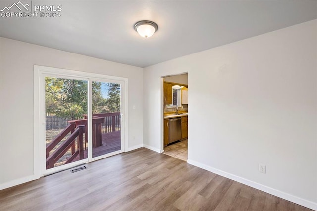 unfurnished room with sink and light wood-type flooring