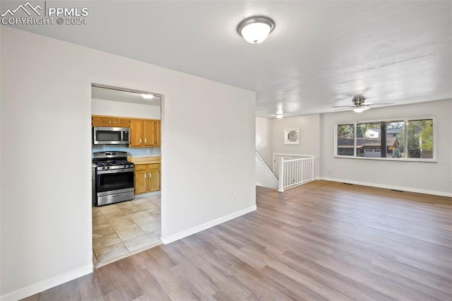 unfurnished living room featuring light hardwood / wood-style floors and ceiling fan