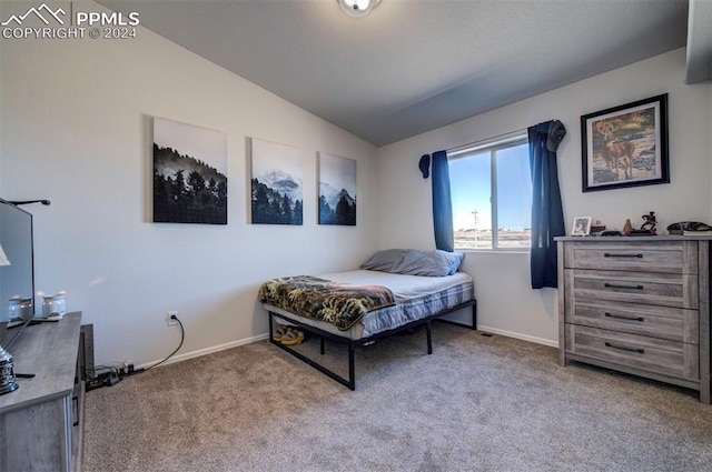 bedroom with lofted ceiling and light carpet