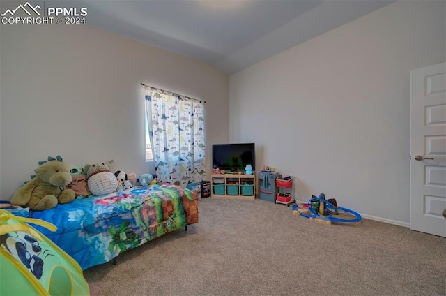 bedroom with carpet flooring and lofted ceiling