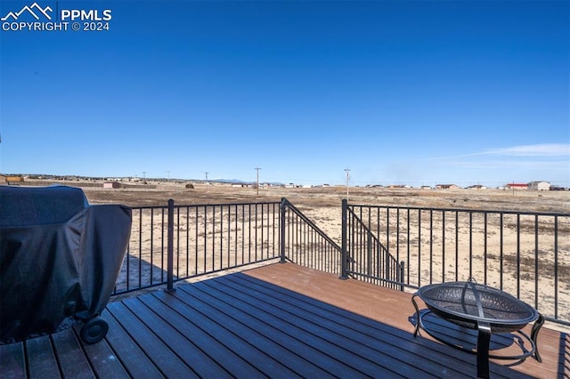 deck with area for grilling and an outdoor fire pit