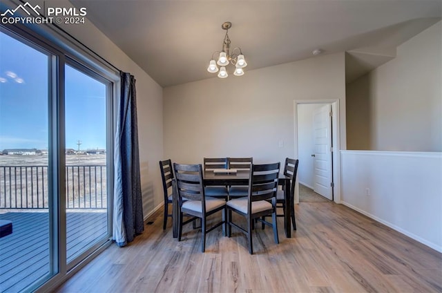 dining room featuring hardwood / wood-style floors and an inviting chandelier