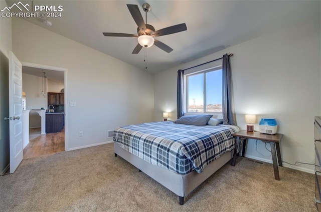 bedroom with ceiling fan, carpet, and vaulted ceiling