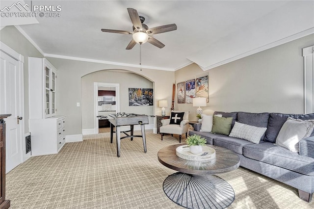 living room with ceiling fan and ornamental molding