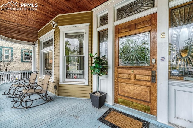 view of exterior entry with covered porch