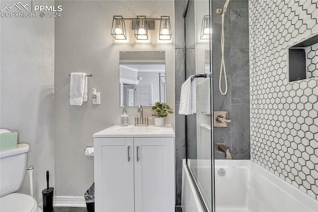 full bathroom featuring vanity, enclosed tub / shower combo, and toilet