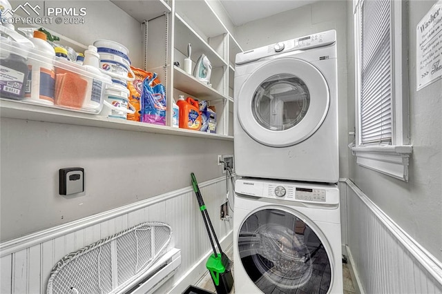 washroom featuring stacked washer / dryer