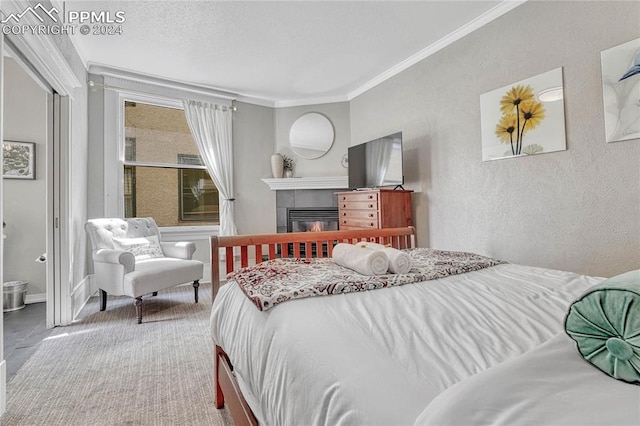 bedroom featuring ensuite bathroom, a fireplace, and crown molding