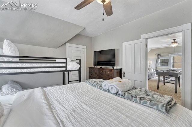 carpeted bedroom with ceiling fan and lofted ceiling