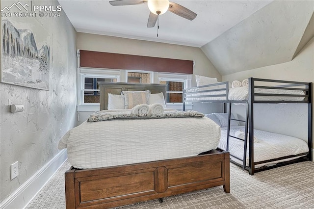 bedroom with light colored carpet, vaulted ceiling, and ceiling fan