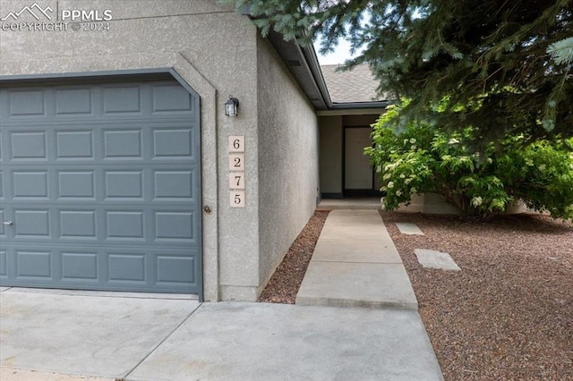 doorway to property featuring a garage