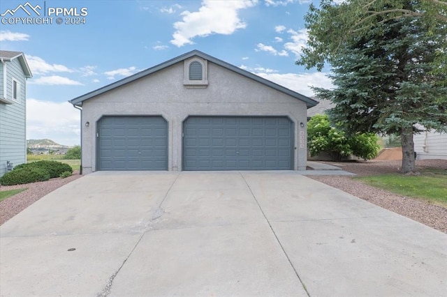 view of front facade featuring a garage and an outdoor structure