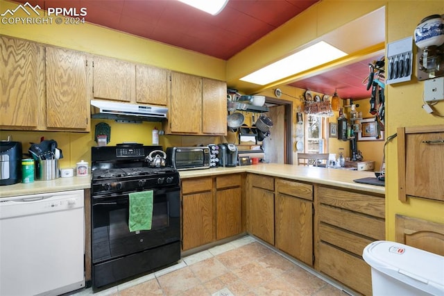 kitchen featuring white dishwasher, black gas range, and light tile patterned floors