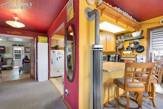 kitchen with stainless steel fridge, carpet flooring, and white fridge