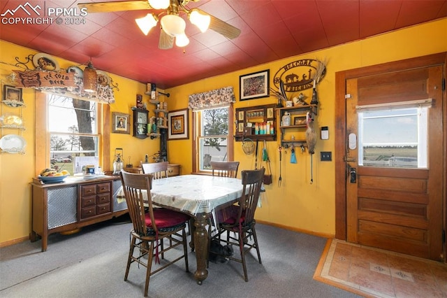 dining room featuring carpet flooring, a wealth of natural light, and ceiling fan