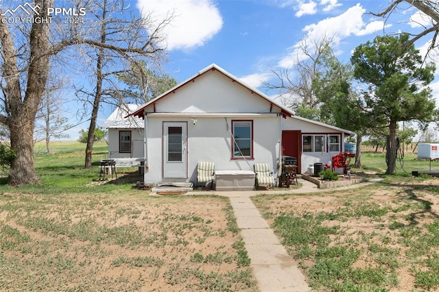 rear view of house with a lawn