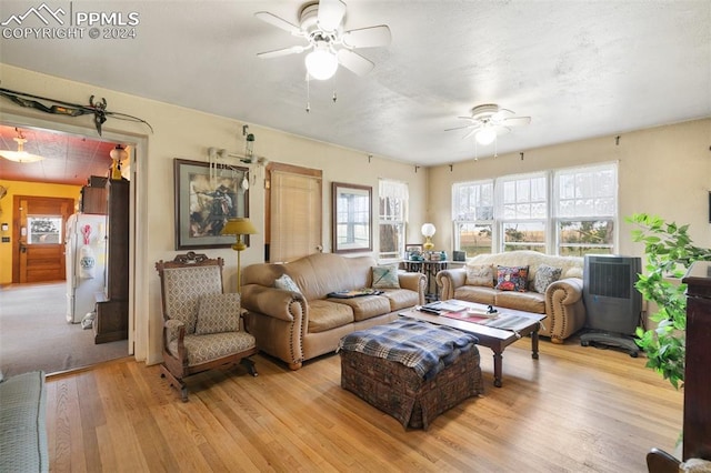 living room with light wood-type flooring and ceiling fan