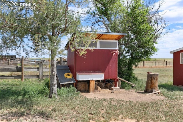 view of outdoor structure with a rural view