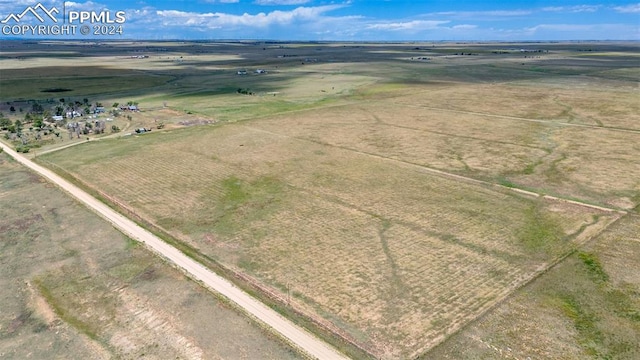 birds eye view of property with a rural view