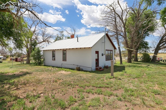 rear view of house with a lawn