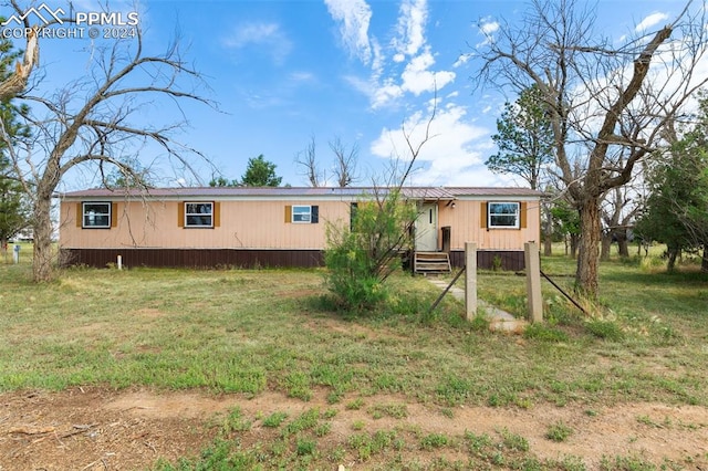 back of property featuring a lawn