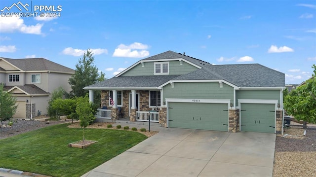 craftsman-style home featuring a garage, a front lawn, and covered porch