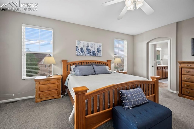 carpeted bedroom with ceiling fan and connected bathroom