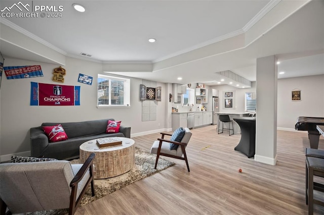 living room with light wood-type flooring, pool table, and crown molding