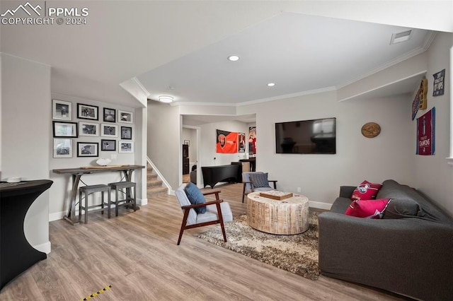 living room featuring light wood-type flooring and ornamental molding