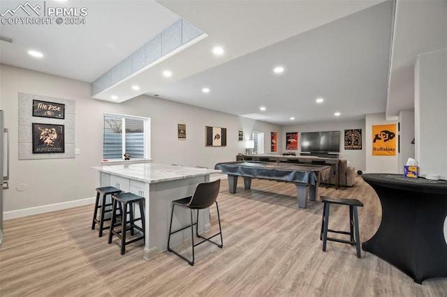 dining area featuring light wood-type flooring and billiards